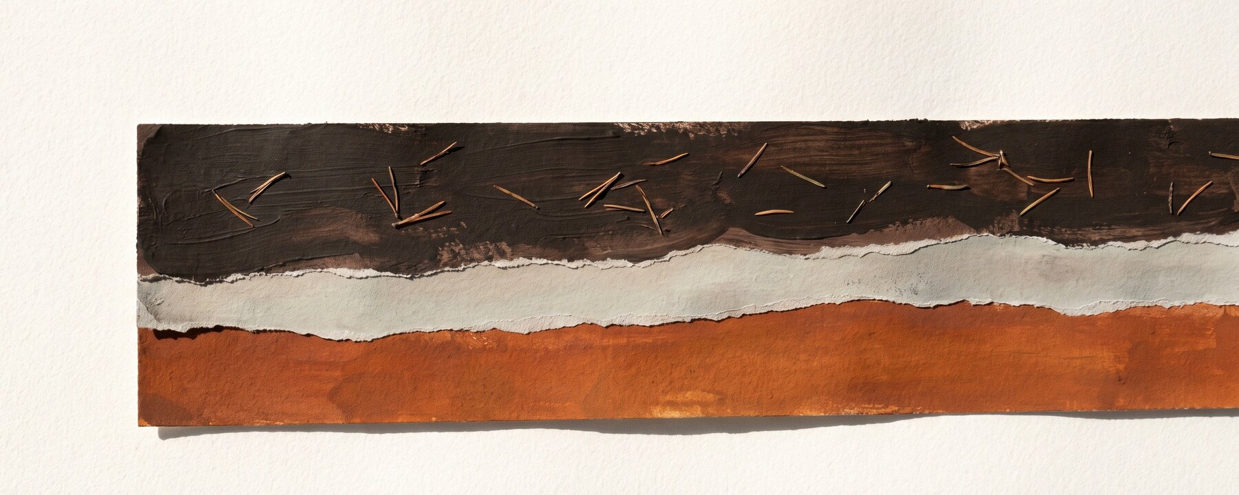 A gouache and torn-paper artwork of a podzol profile: a dark humus band with fir needles, a pale ash-grey band, and a burnt-orange iron band on white paper.